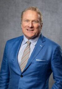 Rugged man in nice blue suit. He has blue eyes and blond hair. 
